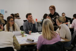 Professor Bewick talking to participants on one of the tables